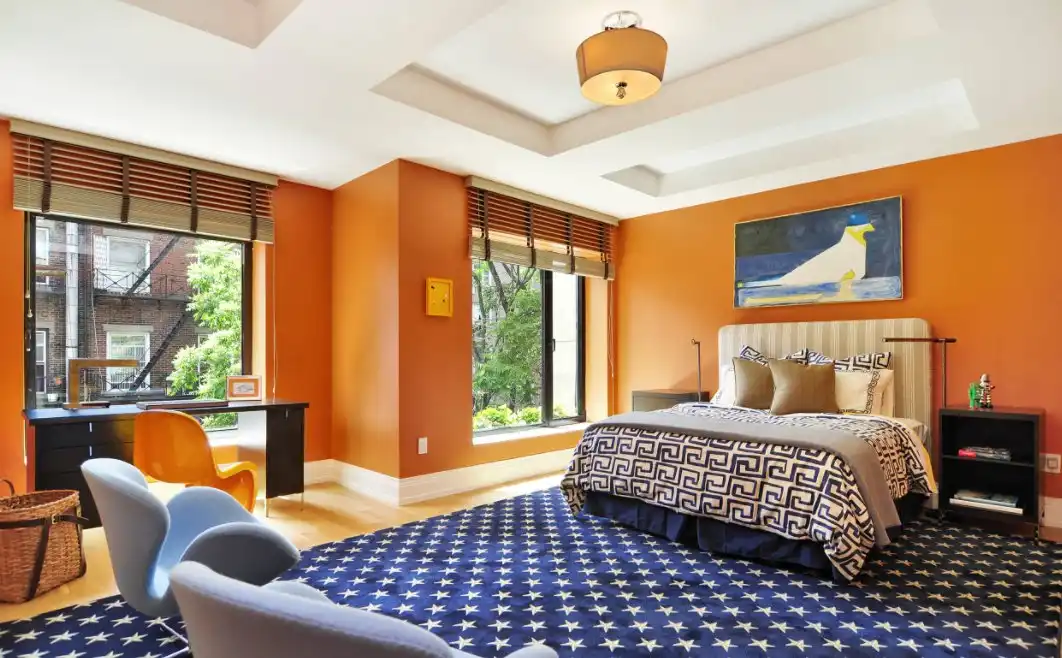 Orange walls bedroom with blue carpet