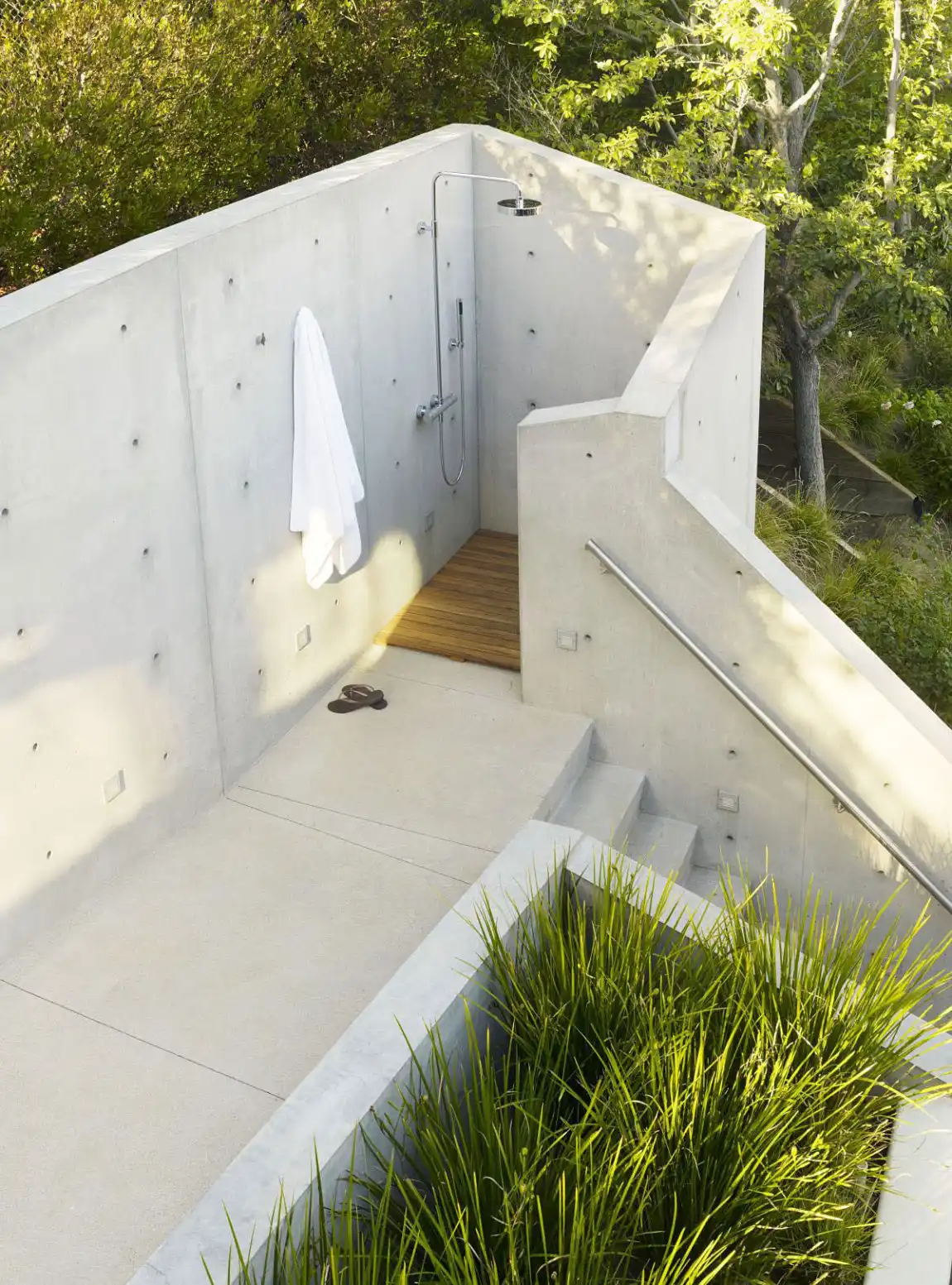 Outdoor shower with concrete wall staircase