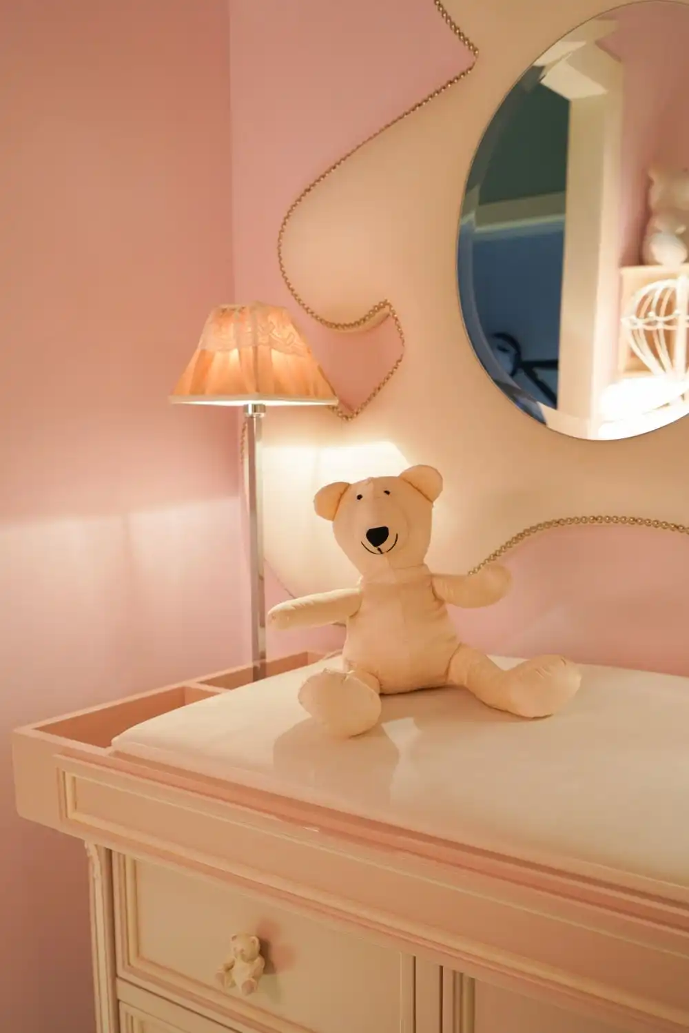 Notice the cute little teddy bear drawer knobs installed on this changing table. They match the mirror