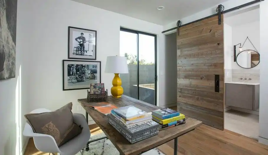Pipes work table and sliding barn door create an indutrial design