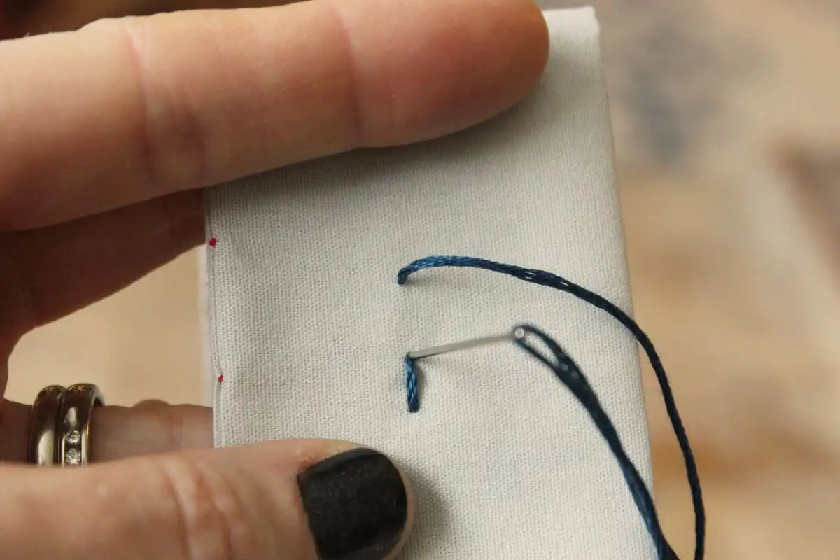 Press the tip of your needle onto the top