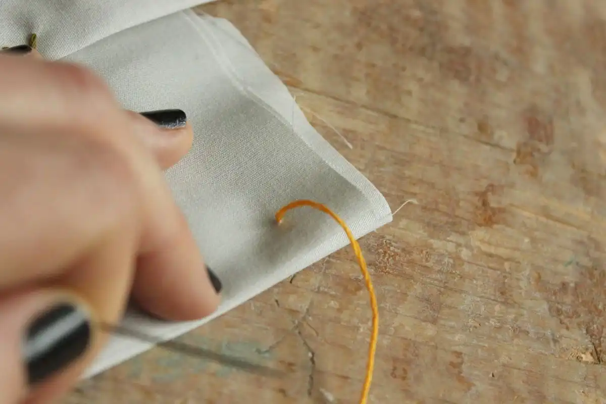 Pull the entire needle and thread through