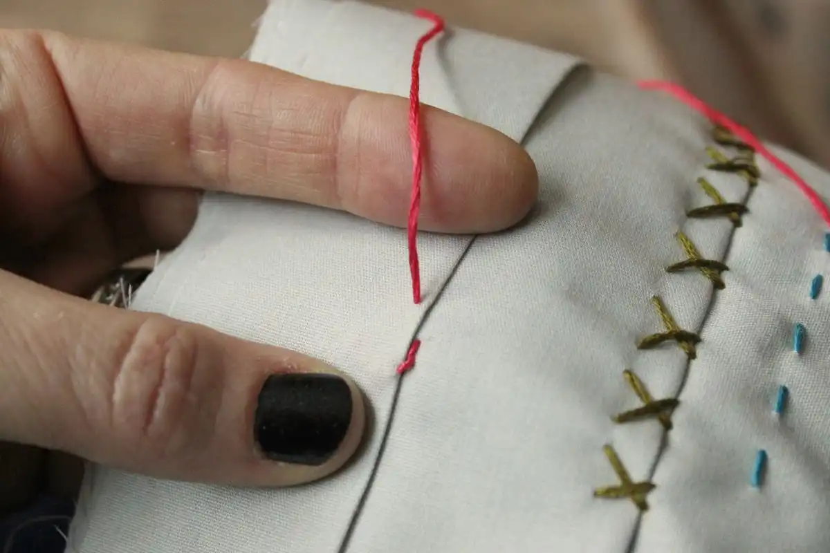 Pull the whole needle and thread through Tip