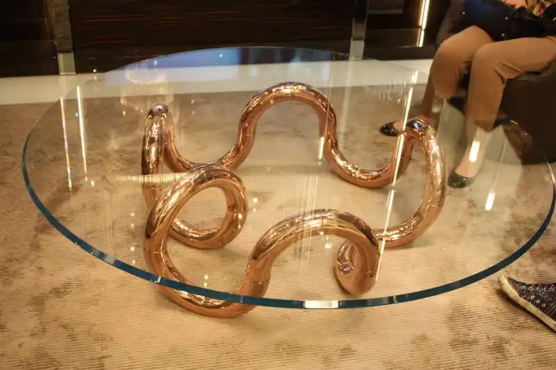 Another glass topped modern coffee table is this one by Reflex, Aenigma Rame, but it has a more substantial curvy metal base. The highly polished copper is an on-trend metallic finish and would nicely accent any living room.