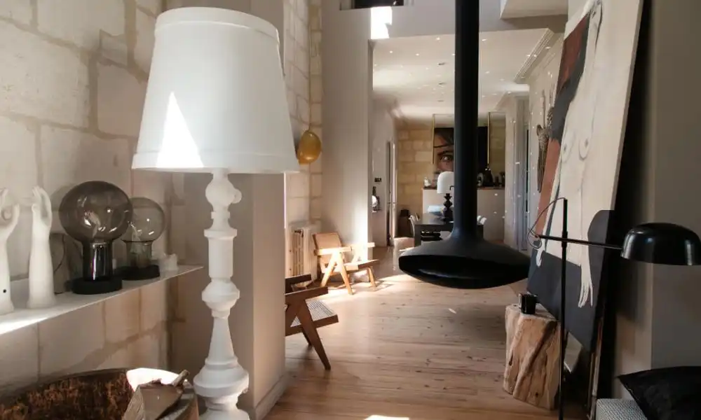 Room with wooden floor and suspended black fireplace