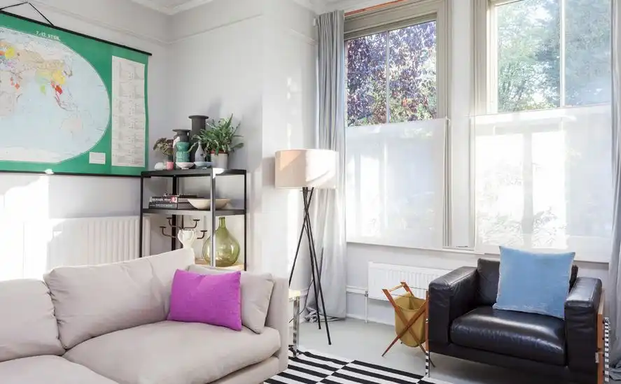 Scandinavian style living room with tripod floor lamp