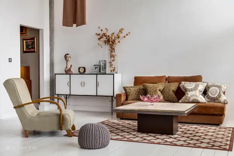 Simple living room decor with a brown leather couch