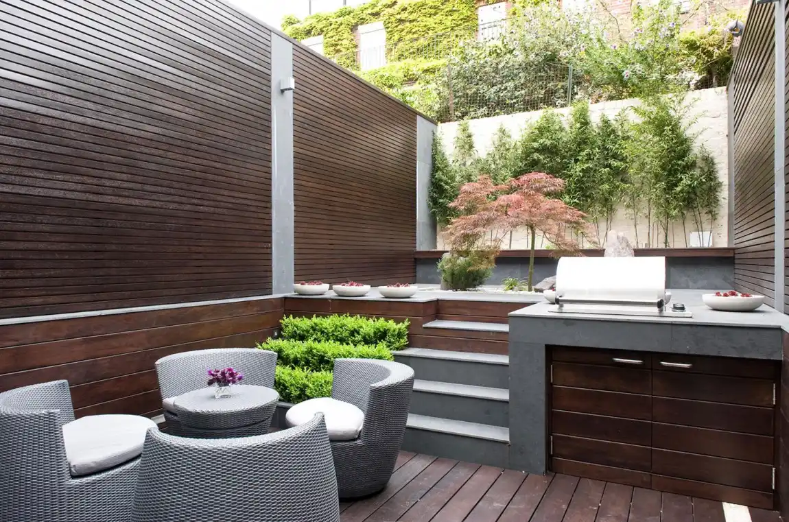 Small backyard with a kitchen and seating area
