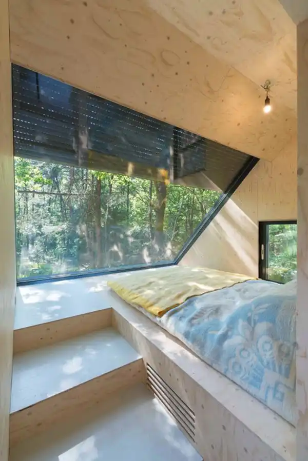 Small cabin in the woods with a rooftop extension dorm