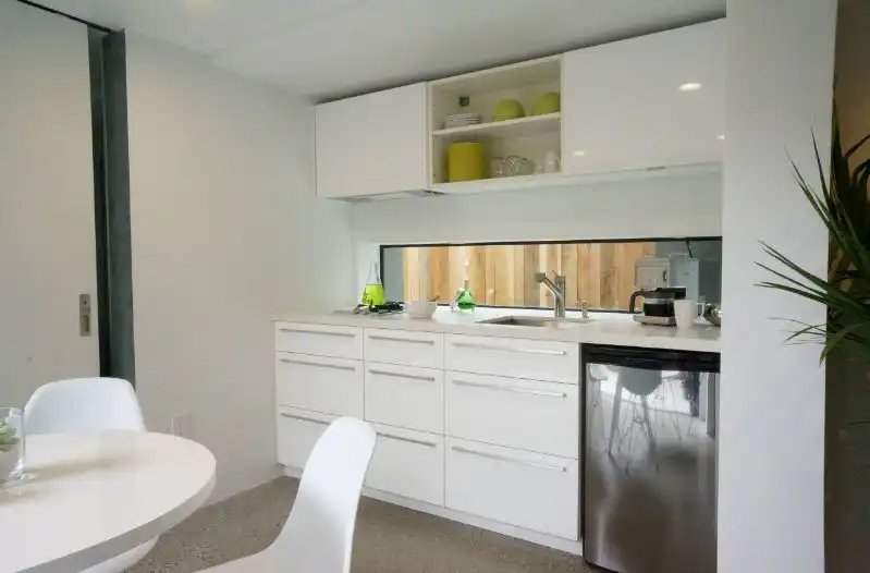 Small white kitchen with tiny windows
