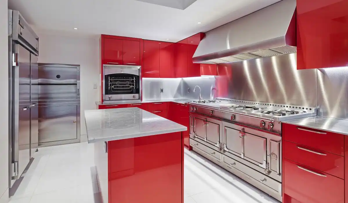 Stainless steel kitchen appliances and red cabinets