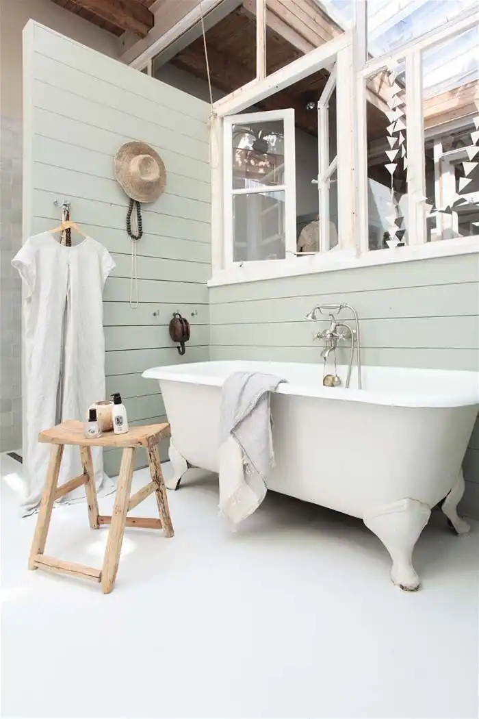 Stalking bathroom with beadboard walls and bathtub