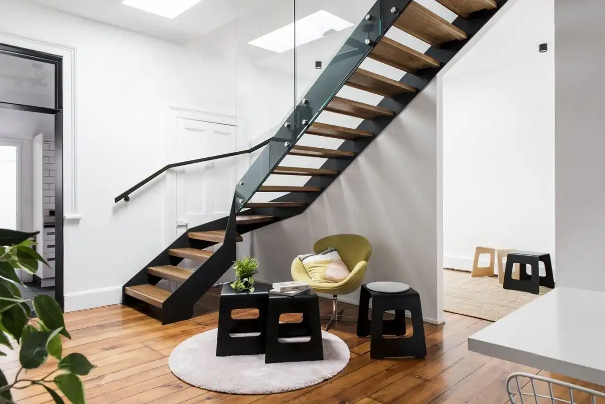 Steel and glass staircase with space storage nook under