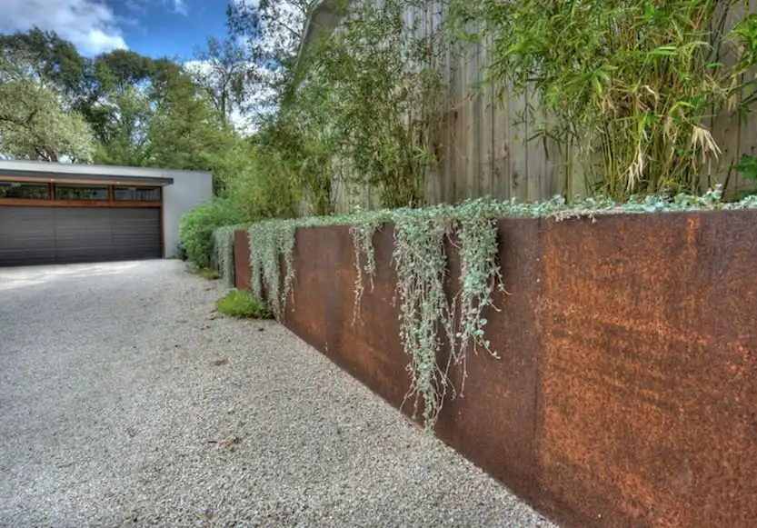 Tall planters from corten used like a fence