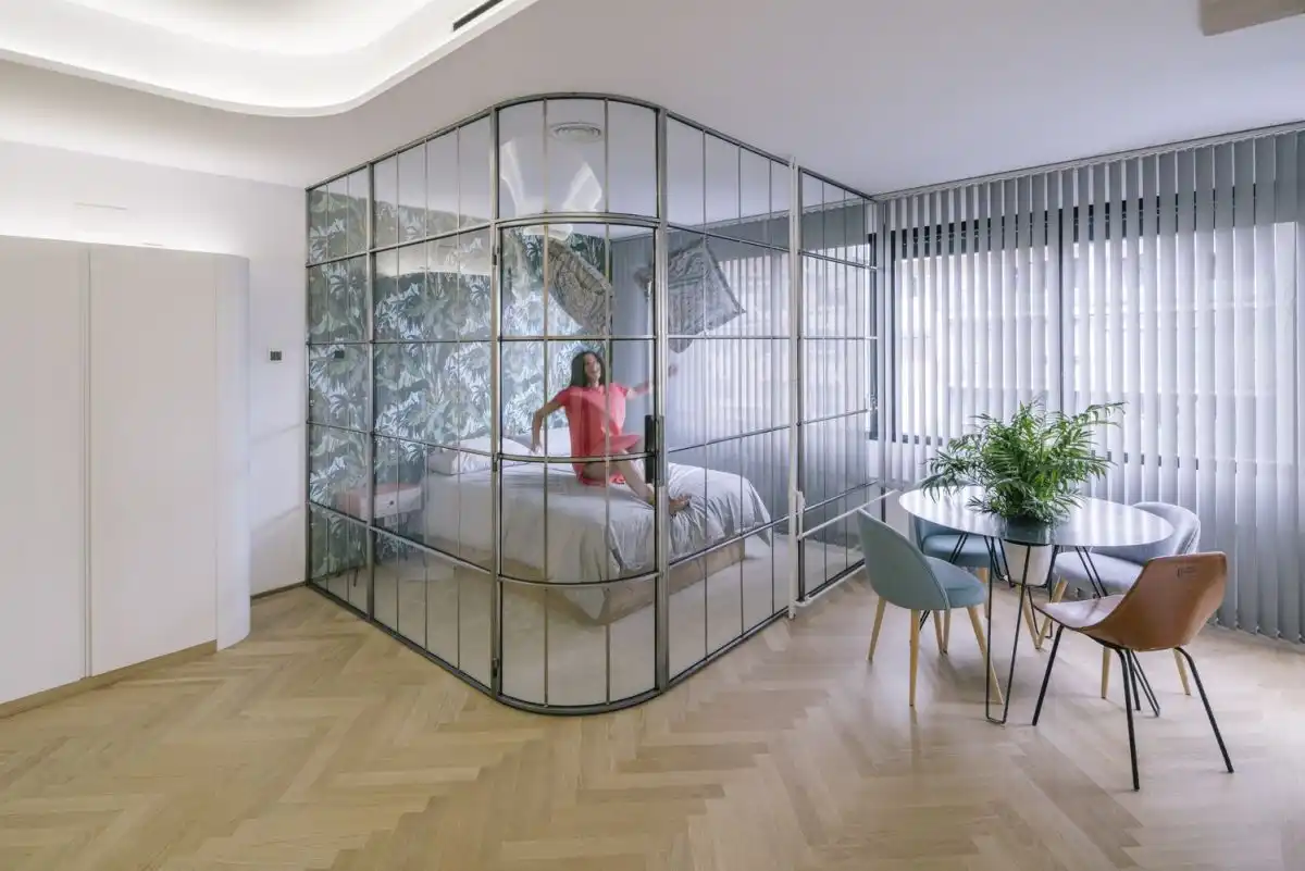 The glass table heightens the open, airy feeling of the apartment.