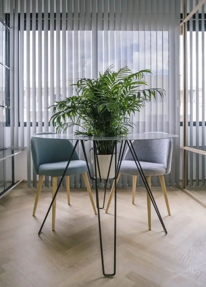 The hole in the table for a potted plant is an unusual feature.