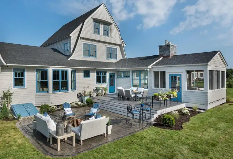 This old classic shingle-style home - large backyard decor with stone floor