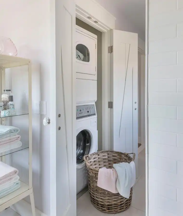 This old classic shingle-style home - laundry room with stacked machines