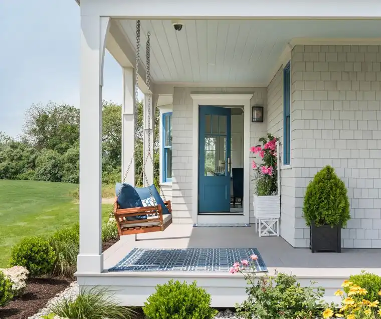 This old classic shingle-style home - porch with hanging bench