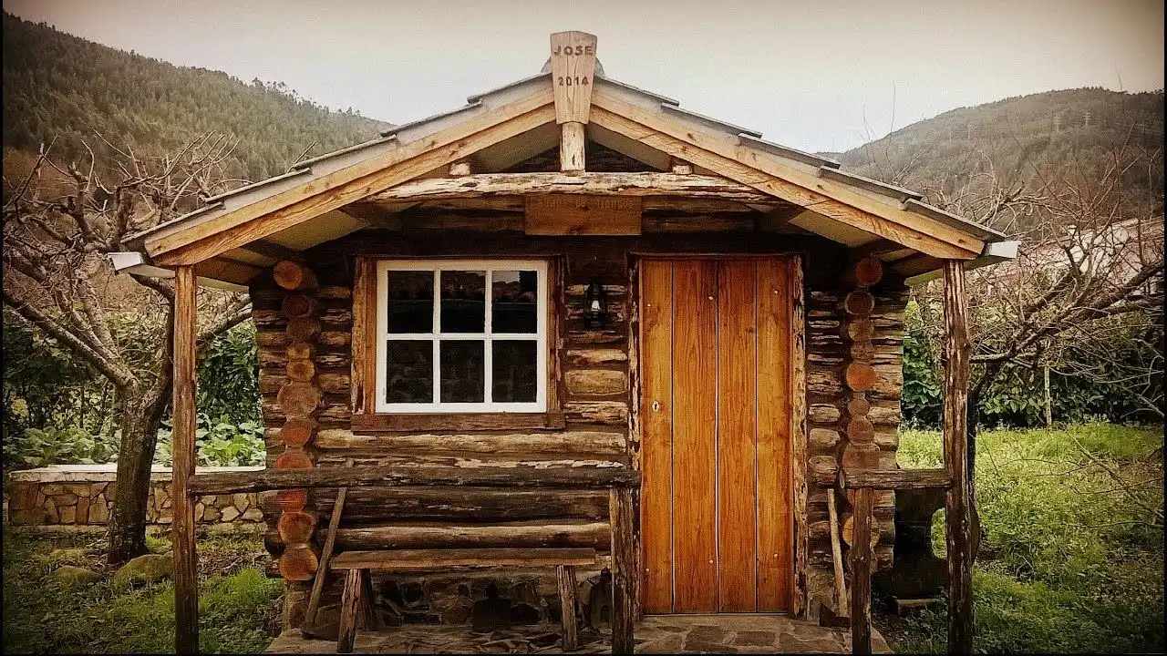 A Cozy-Looking Cabin In The Wood Or In The Mountains