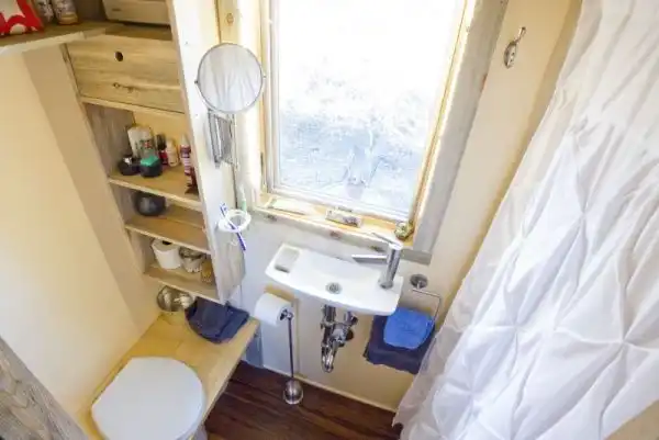 Large window for this tiny bathroom layout.