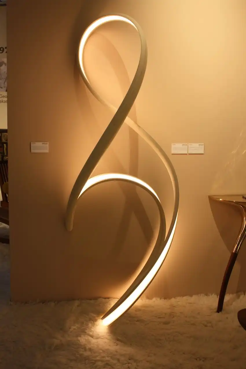 The lamp is made from micro-laminated, cold-pressed bent wood.
