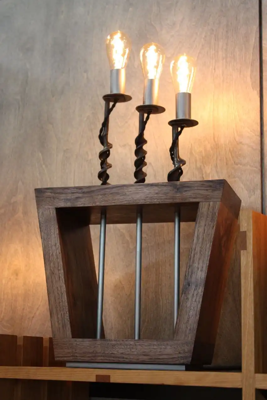 This triple light lamp is our favorite. The shape of the bulbs contributes to the lamps old-world feel and highlights the twists of the bits.