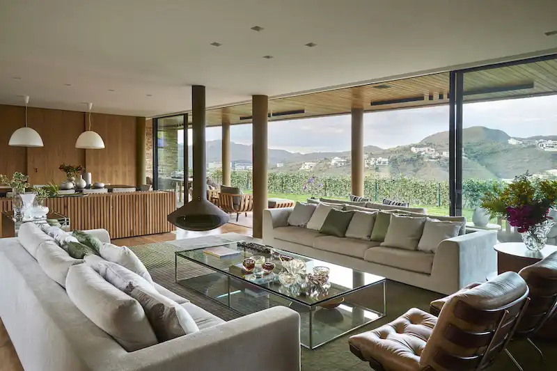 Large windows and sliding glass doors expose the living spaces to the expansive views