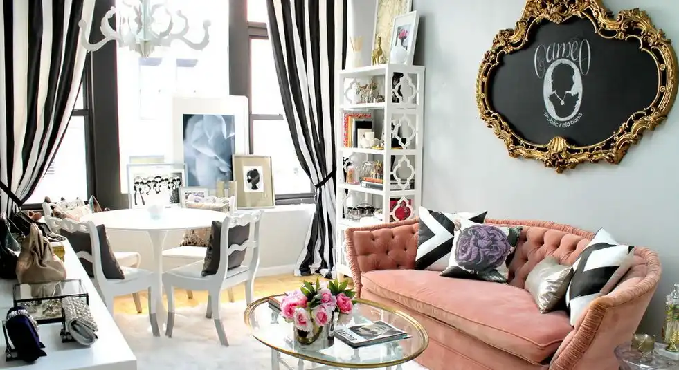 Well decorated living room with pink pale accents and Saarinen Tulip Table