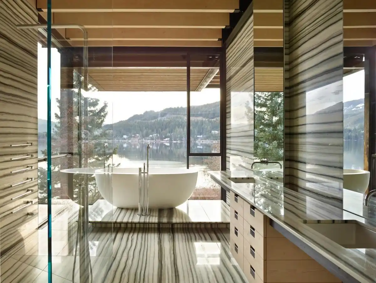 The design of the bathroom emphasizes the tub and view.
