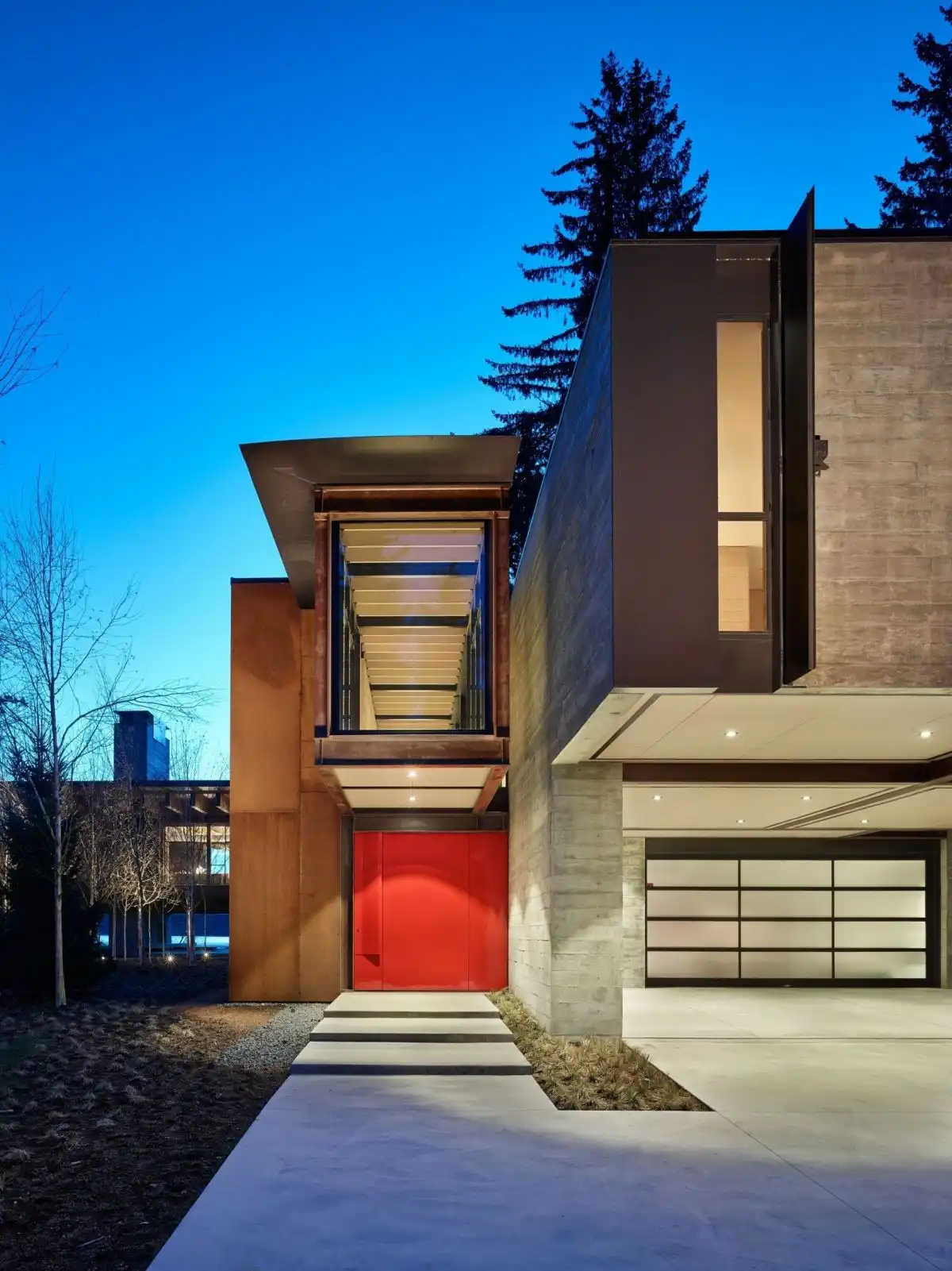 The sole pop of color comes from the oversized entry door.