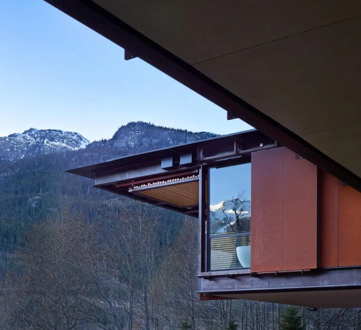 Large windows offer views of the surrounding mountains.