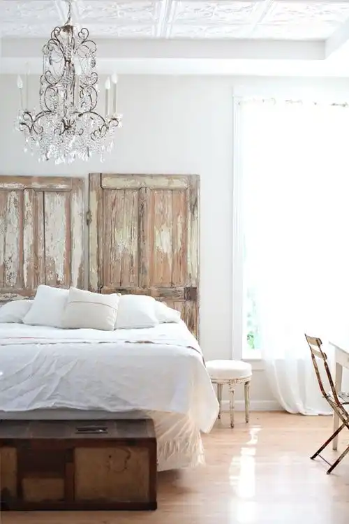 White bedroom with old doors for headboard