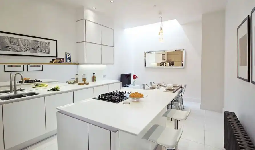White kitchen design with dining area