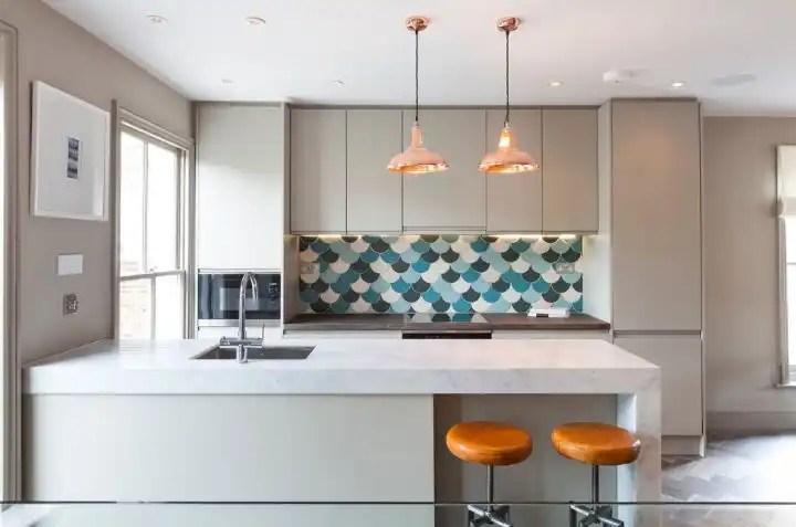 White kitchen with colorful fish scale tiles