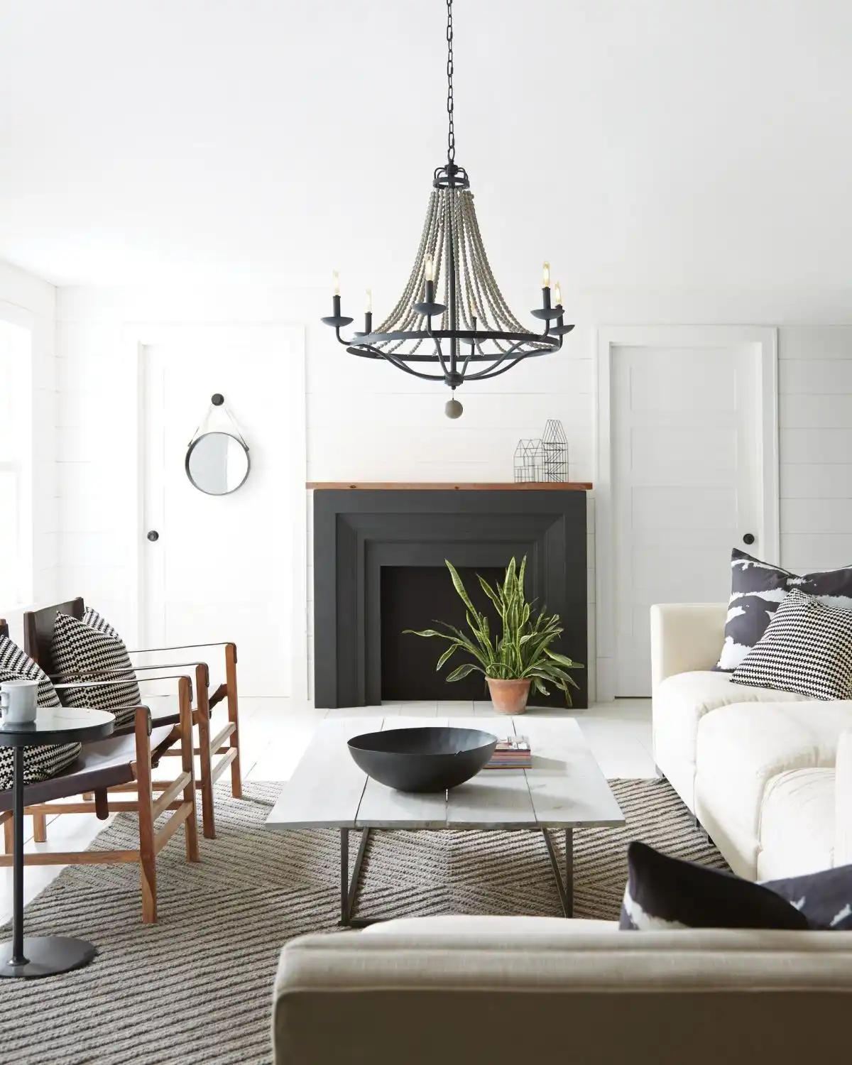 White living room with rustic accents and black chandelier decor