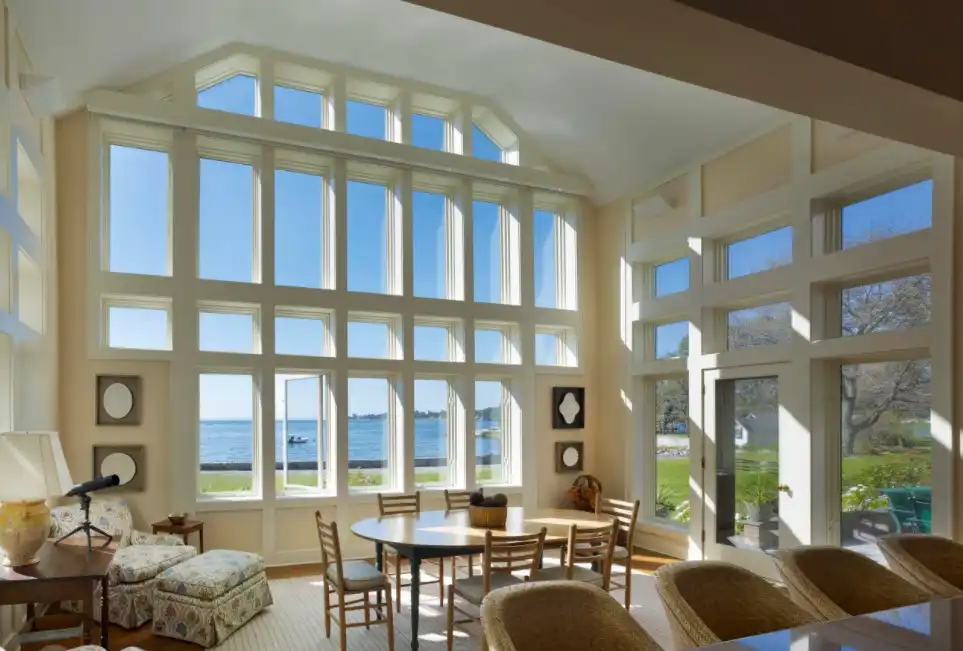 White sunroom decor with large windows framed