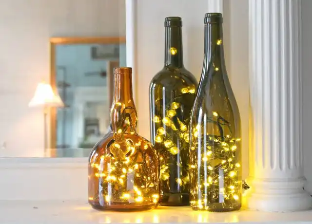 Glass bottle lanterns using string lights