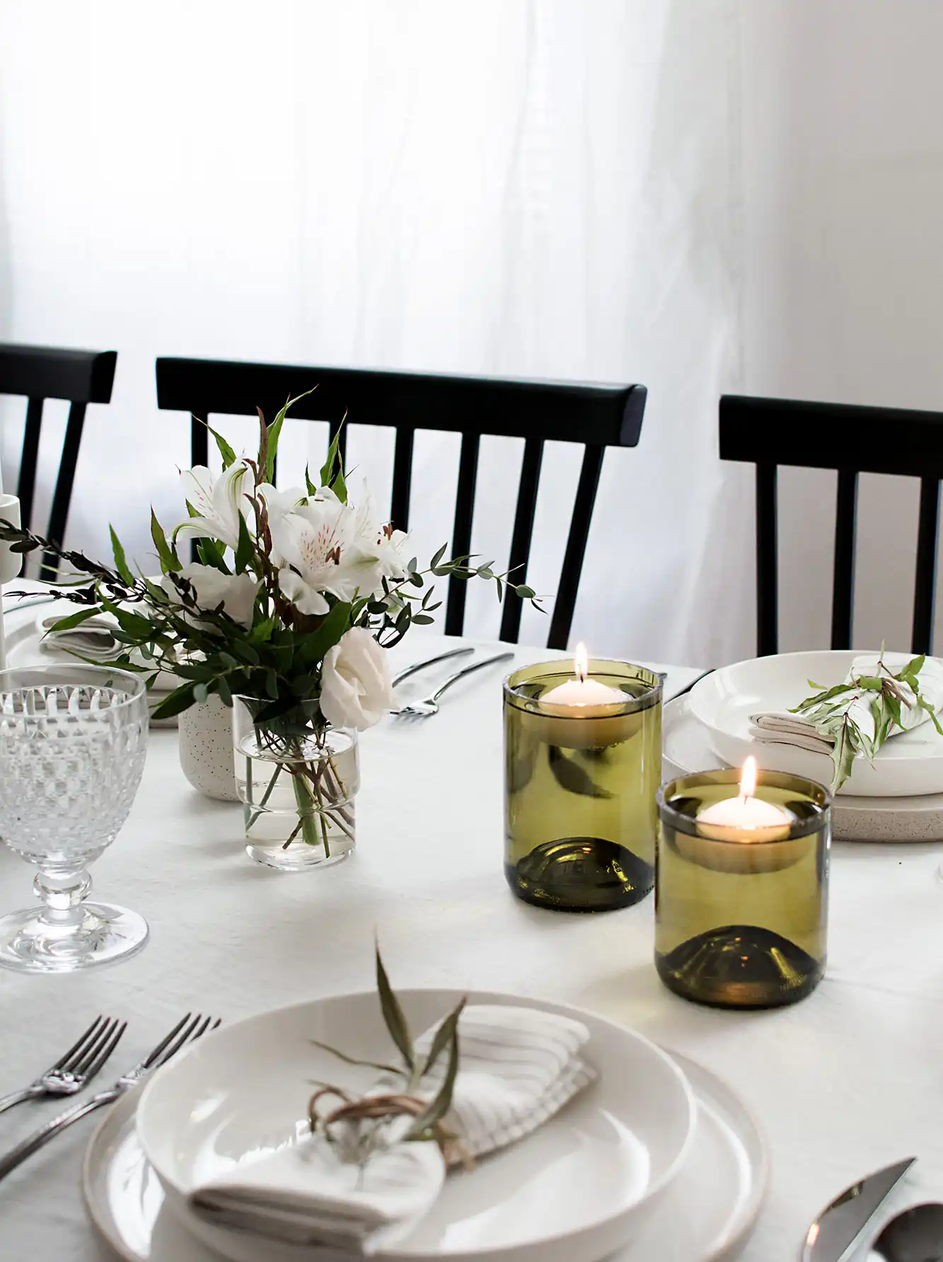Floating candle holders using cut glass bottles