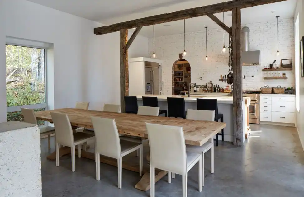 Wood trestle dining table with cream leather chairs