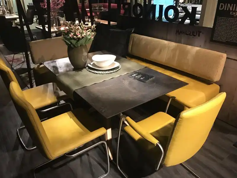 Yellow dining table seatting with bench
