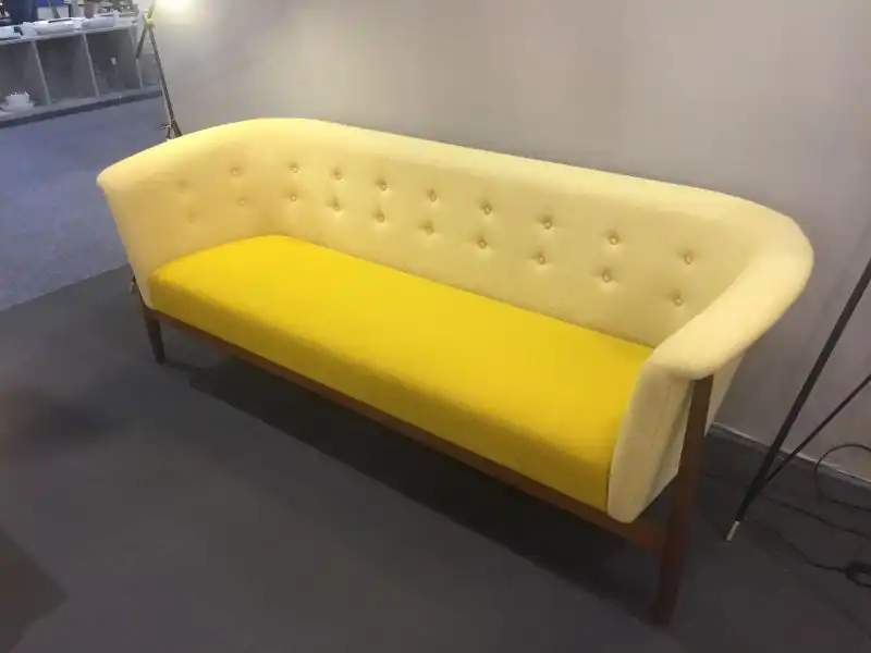 Yellow tufted small sofa