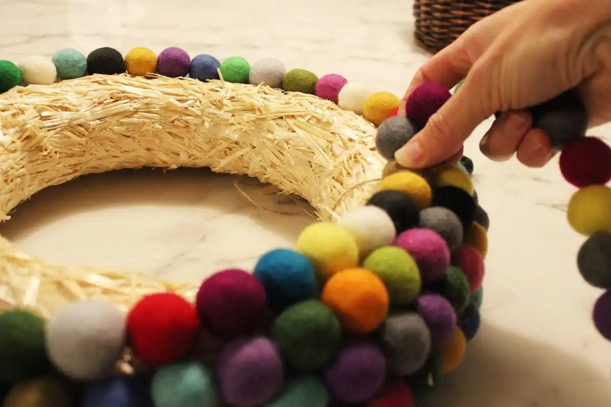 You may find it easier to lay the straw wreath down flat