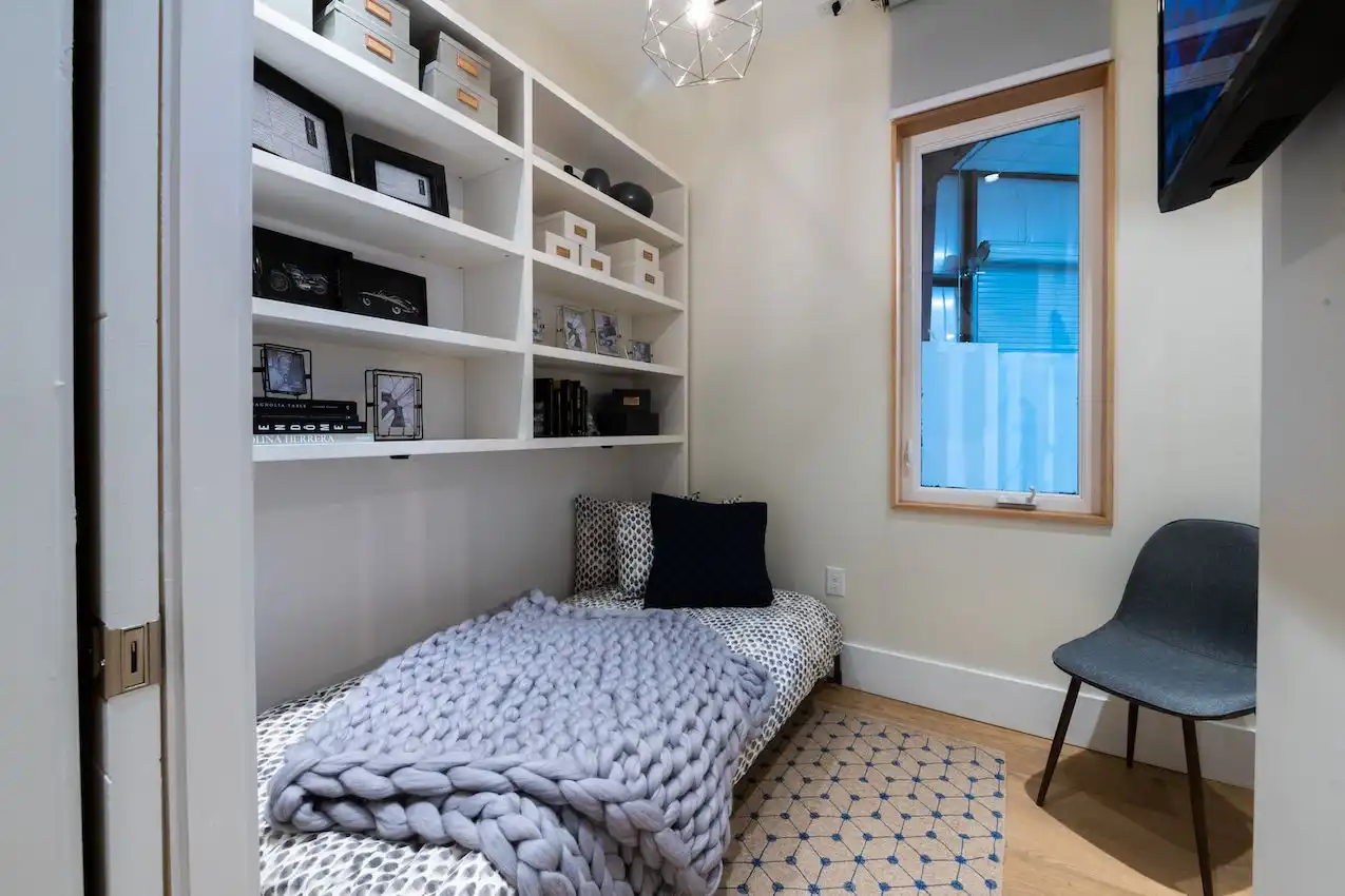 Built-in shelving above the bed makes the most of a space that's usually wasted.
