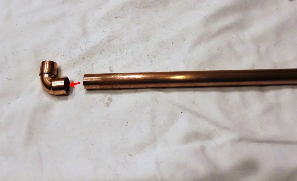 Attaching this capped elbow to the longer pipe