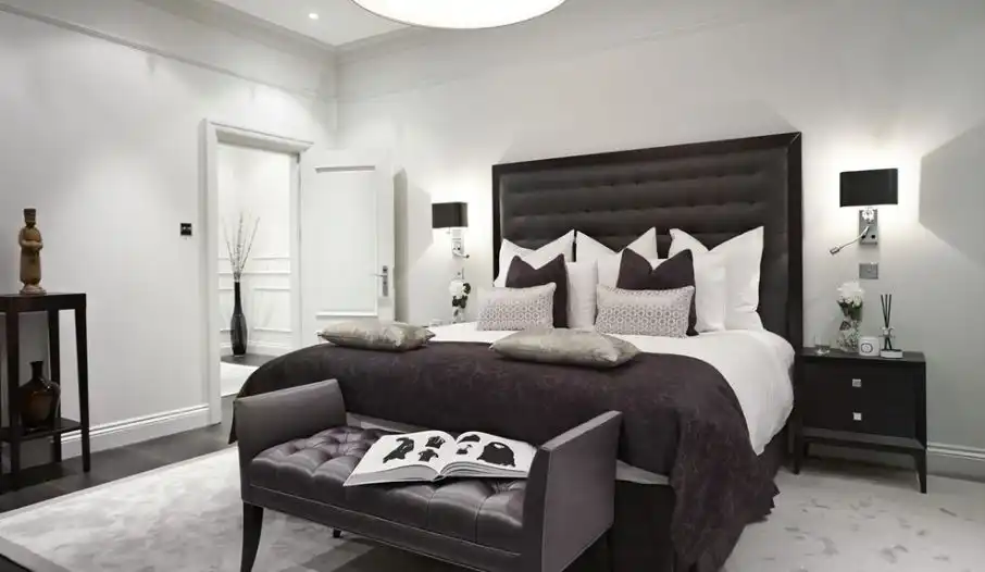Black Headboard Against A White Wall