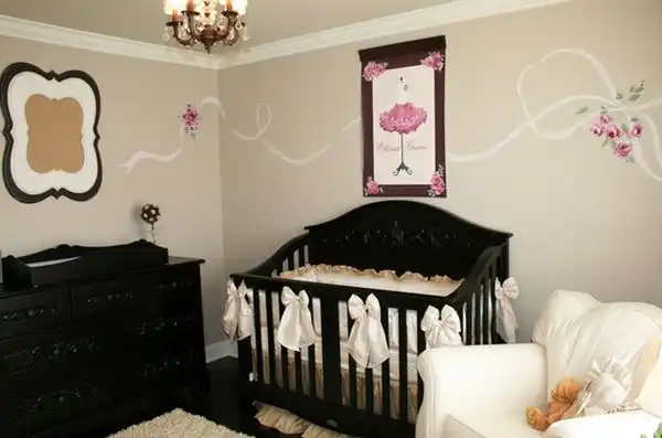 Black nursery furniture with touch of pink on walls