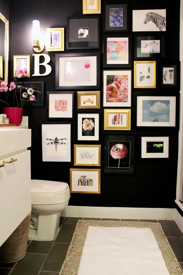 Black wall bathroom decorated with frames