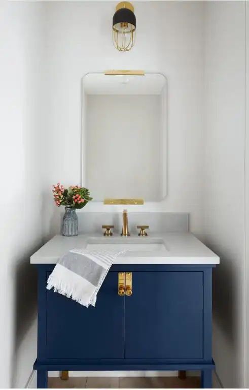 Blue cabinet in half bathroom for sink