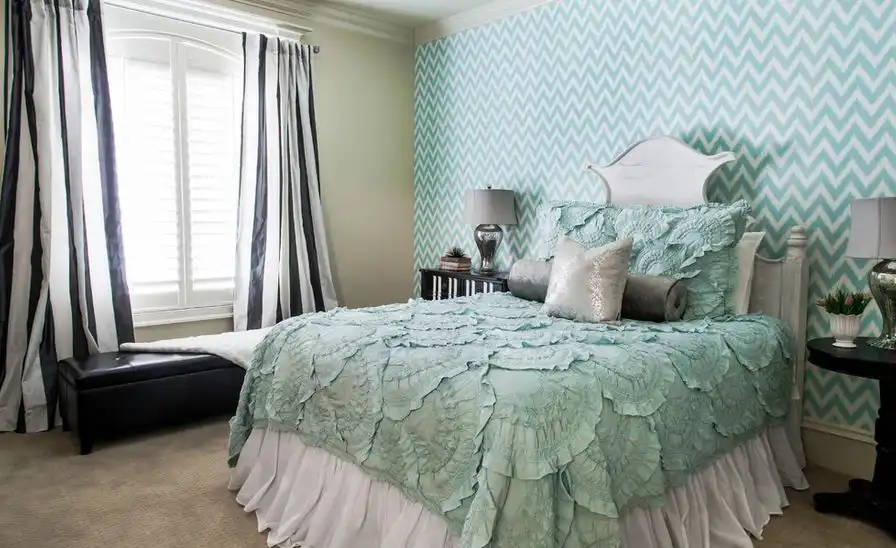Blue themed bedroom with vertical striped black and white curtain